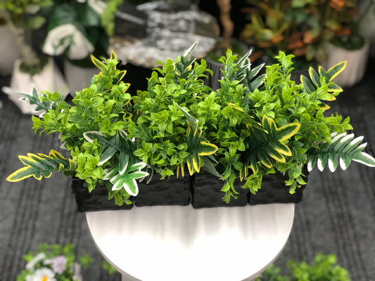 Four artificial greenery pots with mixed tropical leaves