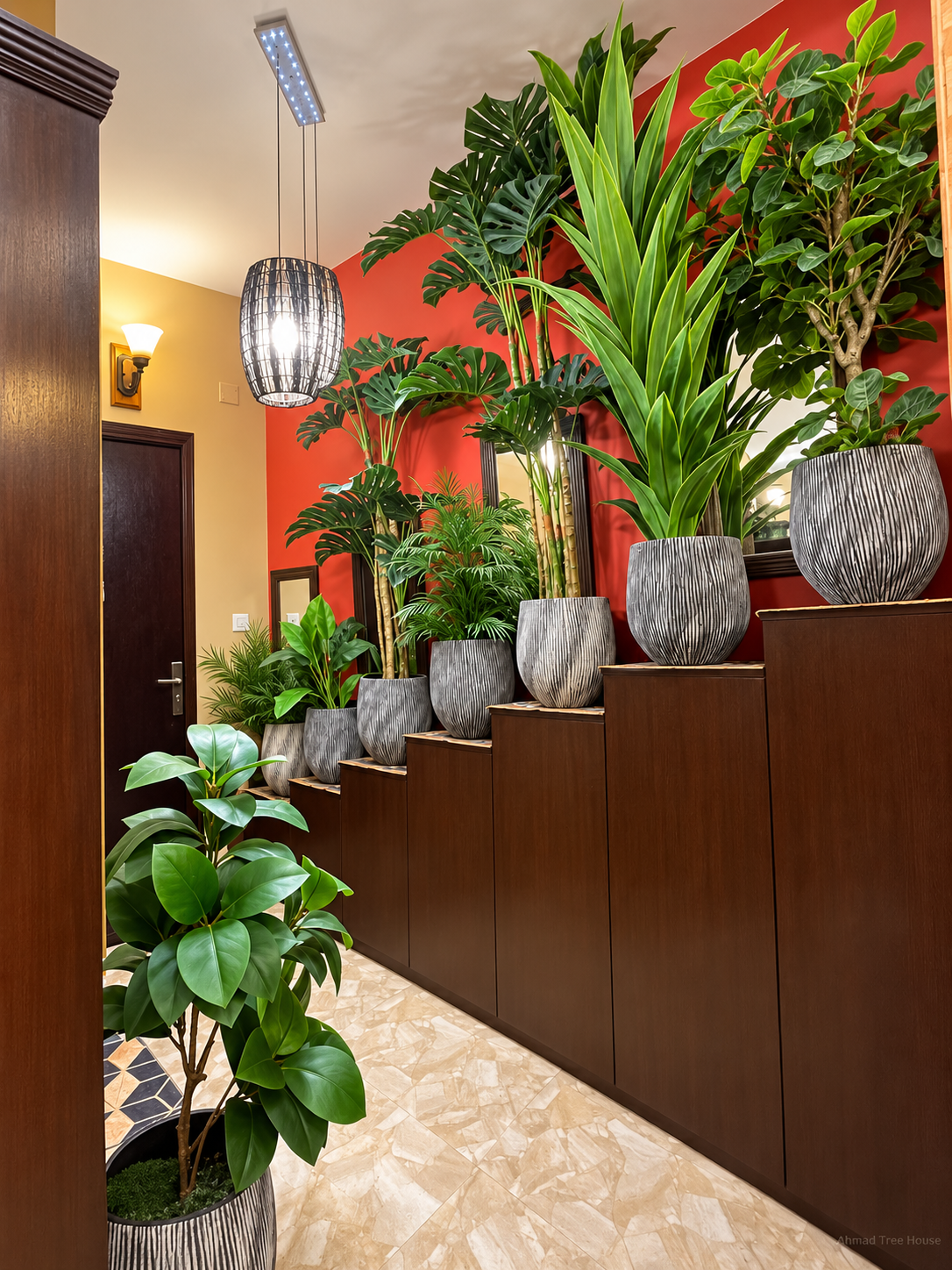 A row of tropical plants in patterned planters along a wooden staircase — Ahmad Tree House project