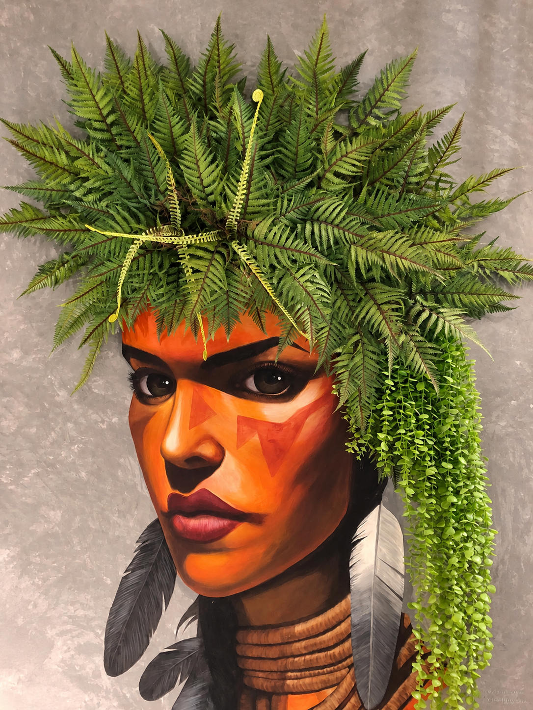 Fern and trailing greenery integrated into a painted portrait mural — Ahmad Tree House project
