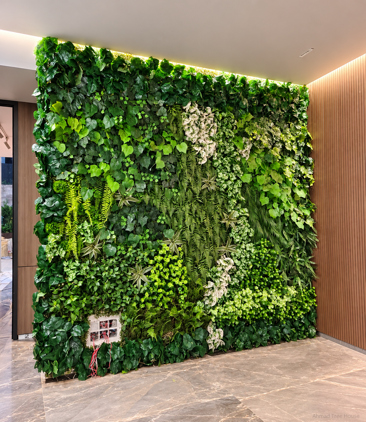 Mixed-leaf vertical garden viewed from an angle — Ahmad Tree House project