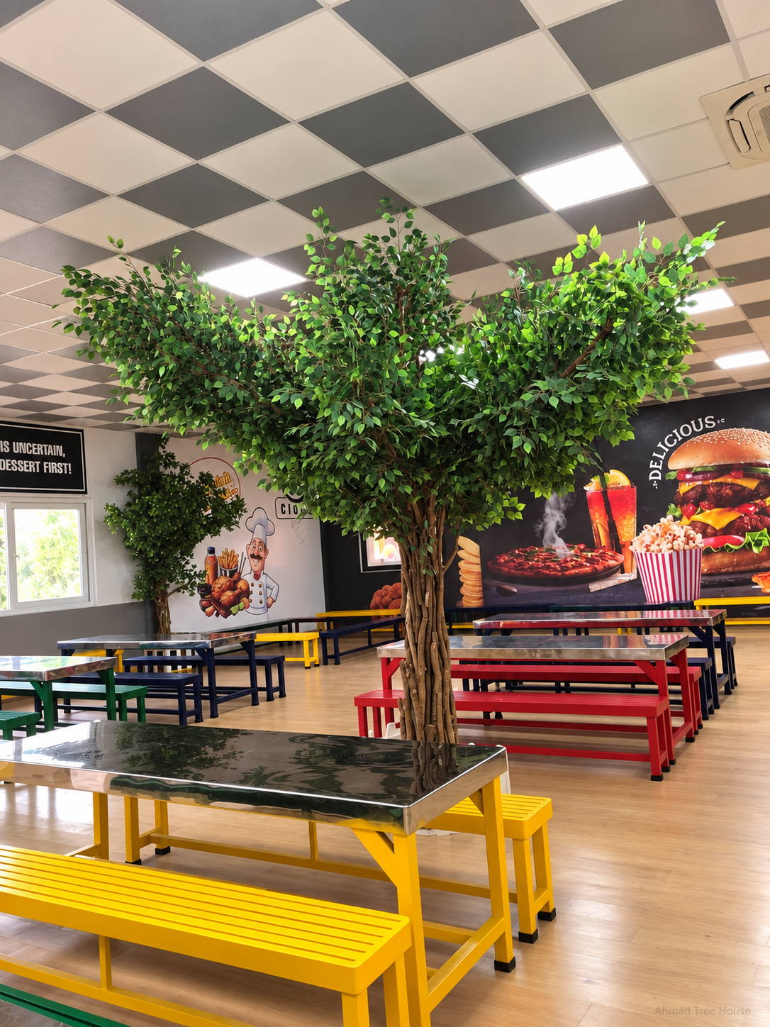 Central restaurant tree and dining benches from a side angle — Ahmad Tree House project