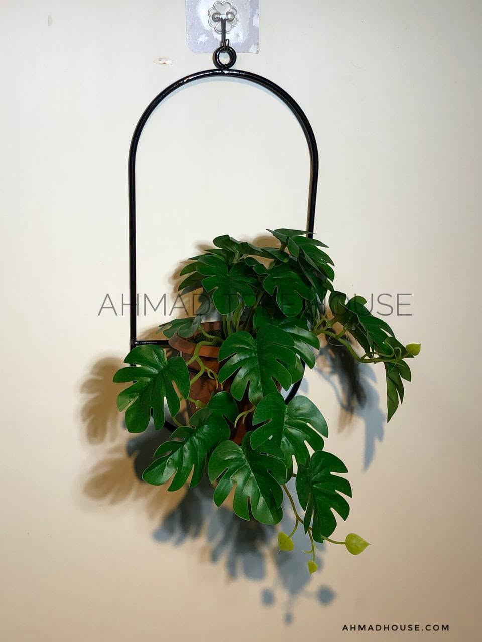 Hanging black metal ring planter with cascading artificial greenery