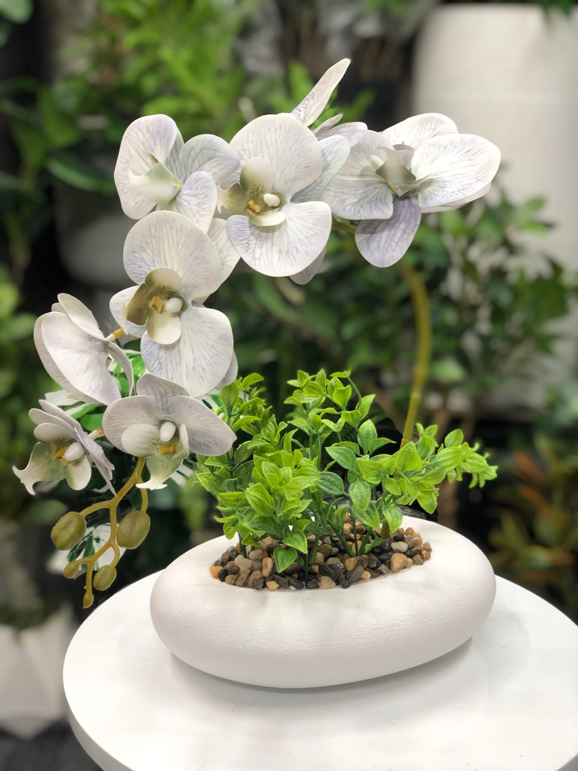 White orchid artificial flower arrangement in decorative pot