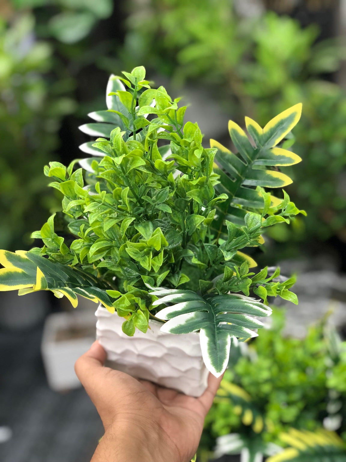 Single artificial greenery arrangement in textured white square pot