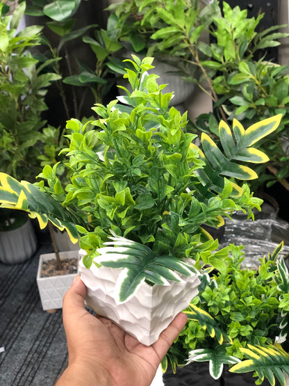 Artificial mixed green foliage arrangement in modern white textured pot
